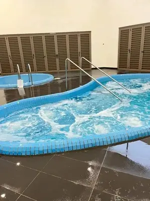 a large swimming pool with blue water in a building at CAMERON HIGHLAND BRINCHANG KEA FARM Homestay By Dcozy 6-7pax in Brinchang