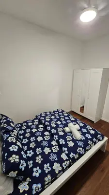 a bedroom with a bed with a blue and white blanket at CAMERON HIGHLAND BRINCHANG KEA FARM Homestay By Dcozy 6-7pax in Brinchang