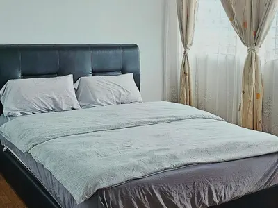 a bed with a blue headboard in a bedroom at Warm Nest Condo 9\u697c\u6e29\u99a8\u5c0f\u5c4b in Sekincan