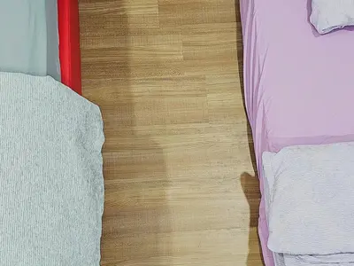 a wooden floor with different types of beds on it at Warm Nest Condo 9\u697c\u6e29\u99a8\u5c0f\u5c4b in Sekincan