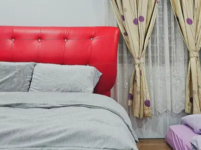 a red bed with a red headboard in a bedroom at Warm Nest Condo 9\u697c\u6e29\u99a8\u5c0f\u5c4b in Sekincan