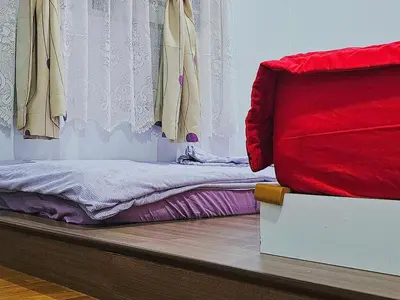 a bedroom with a bed and a window with clothes at Warm Nest Condo 9\u697c\u6e29\u99a8\u5c0f\u5c4b in Sekincan