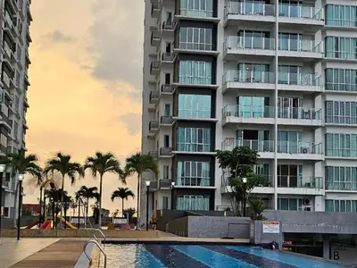 a large apartment building with a swimming pool and palm trees at Warm Nest Condo 9\u697c\u6e29\u99a8\u5c0f\u5c4b in Sekincan