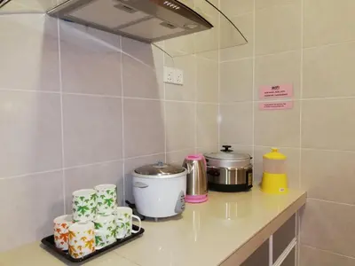 a kitchen with a counter top with cakes on it at COOL Stay Cameron Golden Hills in Brinchang