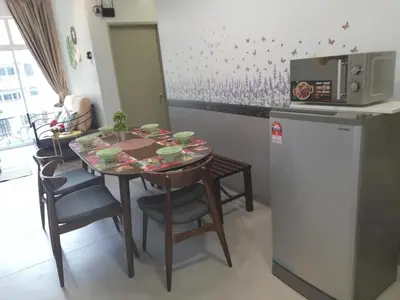 a kitchen with a table and chairs and a refrigerator at COOL Stay Cameron Golden Hills in Brinchang