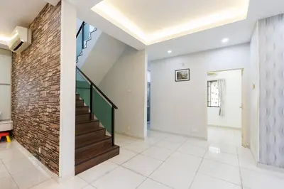 a staircase in a house with a brick wall at Comfy Bungalow Family House Pg Hill & Kek Lok Si in Ayer Itam