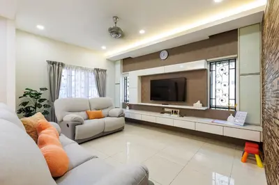 a living room with a couch and a tv at Comfy Bungalow Family House Pg Hill & Kek Lok Si in Ayer Itam