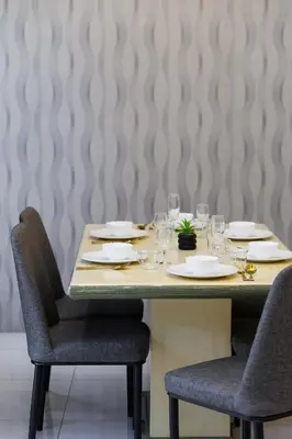 a table with chairs and plates and wine glasses at Comfy Bungalow Family House Pg Hill & Kek Lok Si in Ayer Itam