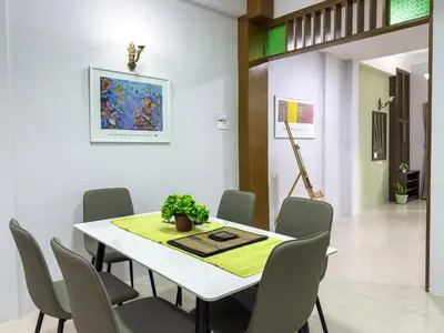 a dining room with a white table and chairs at Gracious Green Gurney in George Town