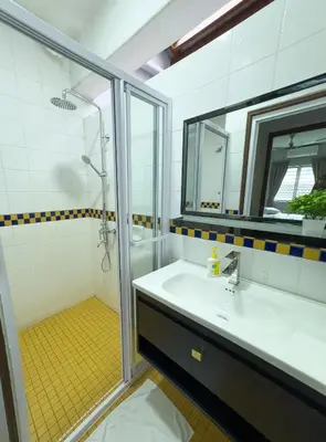a bathroom with a sink and a shower at Gracious Green Gurney in George Town