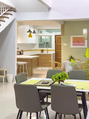 a kitchen and dining room with a table and chairs at Gracious Green Gurney in George Town