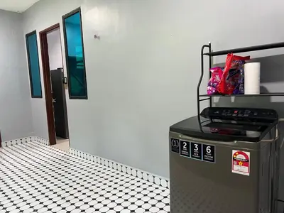 a trash can in a room with a black and white floor at Singgah homestay 2 in Sitiawan