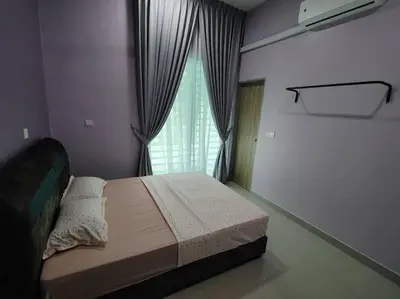 a bedroom with a large bed with a window at Singgah homestay 2 in Sitiawan