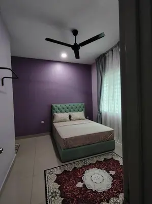 a bedroom with a bed and a ceiling fan at Singgah homestay 2 in Sitiawan