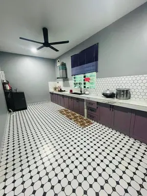 a kitchen with a ceiling fan in a room at Singgah homestay 2 in Sitiawan