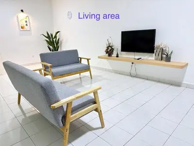 a living room with a chair and a television at POP Stay \u6cca\u5c45 Sungai Bakap Jawi in Kampong Gurun