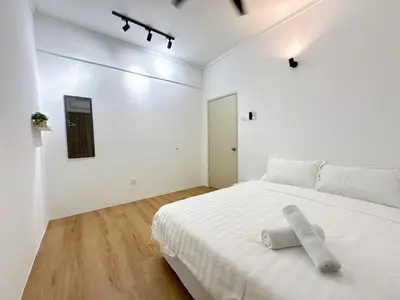 a white bedroom with a white bed with a towel on it at POP Stay \u6cca\u5c45 Sungai Bakap Jawi in Kampong Gurun