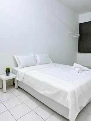 a white bedroom with a large bed with white sheets at POP Stay \u6cca\u5c45 Sungai Bakap Jawi in Kampong Gurun