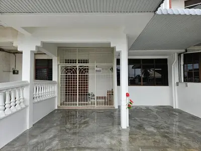a white house with a bird cage on the porch at Leisure Homestay in Nibung Tebal