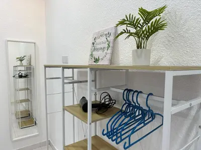 a shelf with a potted plant on top of it at Leisure Homestay in Nibung Tebal