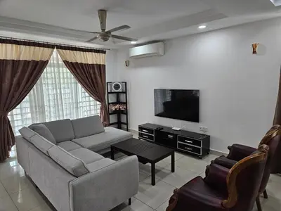 a living room with a couch and a tv at Leisure Homestay BM in Bukit Mertajam