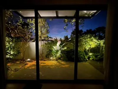 a window view of a garden at night at Mega Seaview Escape - Butterworth Penang in Butterworth