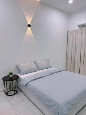 a white bedroom with a large bed and a lamp at Maple Home BM in Bukit Mertajam