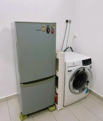 a refrigerator next to a washing machine in a room at Maple Home BM in Bukit Mertajam