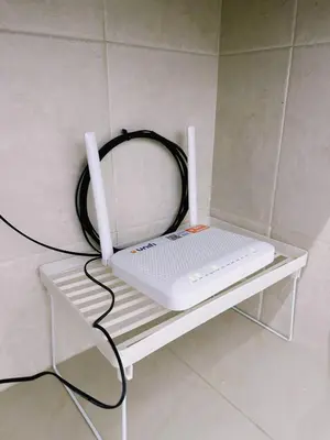 a white laptop sitting on a shelf on a wall at Maple Home BM in Bukit Mertajam