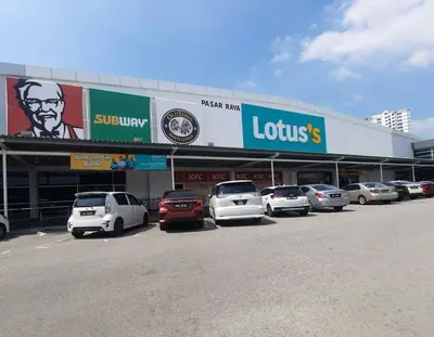 a parking lot with cars parked in front of a store at Maple Home BM in Bukit Mertajam