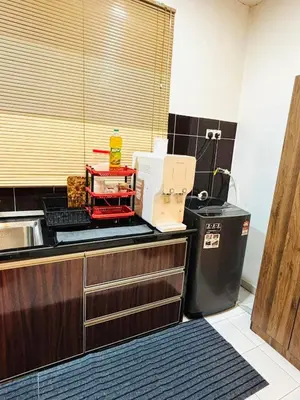 a kitchen with a sink and a counter top at Effa Homestay in Sungai Petani
