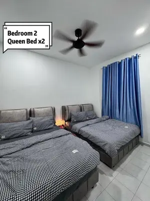 a bedroom with two beds and a ceiling fan at Pantai Remis 116 Minsu Homestay in Pantai Remis