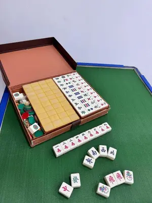a chess board with playing cards on a table at Pantai Remis 116 Minsu Homestay in Pantai Remis
