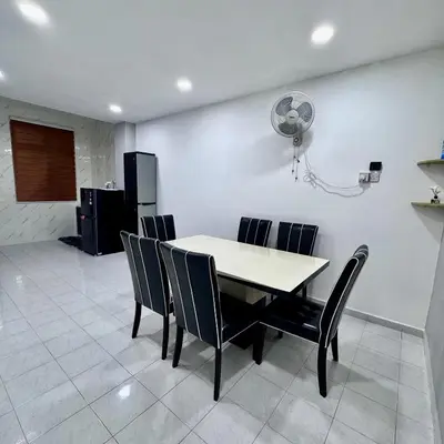 a dining room with a table and chairs at Pantai Remis 116 Minsu Homestay in Pantai Remis