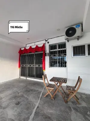 a pair of chairs and a table in a garage at Pantai Remis 116 Minsu Homestay in Pantai Remis