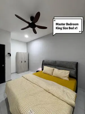 a bedroom with a bed and a ceiling fan at Pantai Remis 116 Minsu Homestay in Pantai Remis