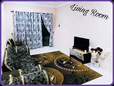 a living room with a couch and a television at Nizaman's Homestay Gerik in Gerik