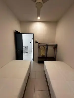a room with two beds and a door to a hallway at Teratak MakTeh in Kampong Ayer Melintas Besar