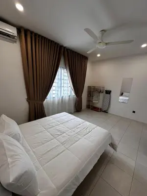 a bedroom with a large white bed and a window at Teratak MakTeh in Kampong Ayer Melintas Besar