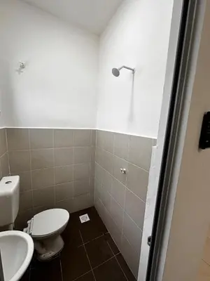 a bathroom with a toilet and a sink at Teratak MakTeh in Kampong Ayer Melintas Besar