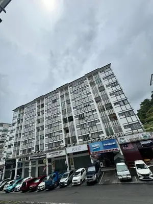 a large apartment building with cars parked in a parking lot at AYAAN HOMESTAY Tanah Rata with Netflix in Tanah Rata