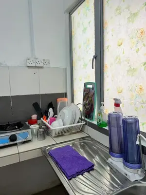 a kitchen counter with a sink and a window at AYAAN HOMESTAY Tanah Rata with Netflix in Tanah Rata