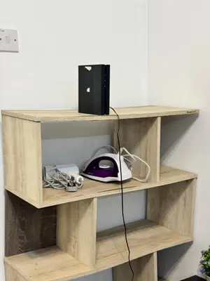 a wooden shelf with a computer mouse on it at AYAAN HOMESTAY Tanah Rata with Netflix in Tanah Rata