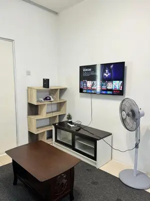 a room with a desk and a tv on a wall at AYAAN HOMESTAY Tanah Rata with Netflix in Tanah Rata