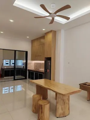 a kitchen with a wooden table and a ceiling fan at Ipoh M Villa in Ipoh