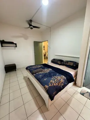 a bedroom with a bed and a ceiling fan at AYAAN Prima Homestay 1 with Netflix in Tanah Rata