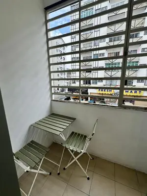 a chair and a window in a room with a building at AYAAN Prima Homestay 1 with Netflix in Tanah Rata