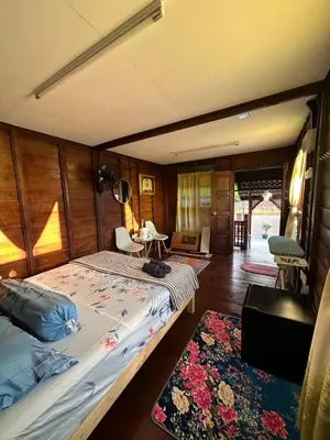 a bedroom with a bed in a room at Homestay Singgah Keluarga Warisan Abg Tam in Kepala Batas