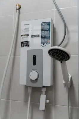 a soap dispenser in the corner of a bathroom at VibeHaus Snooker SimpangAmpat ``` 4Room10Pax3Bath in Simpang Ampat