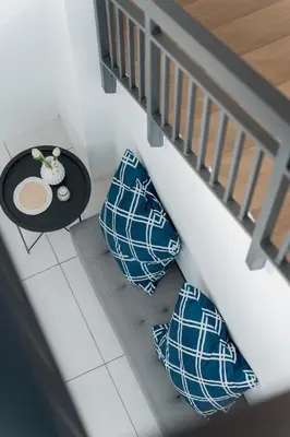 two pillows and a table on the floor next to a staircase at VibeHaus Snooker SimpangAmpat ``` 4Room10Pax3Bath in Simpang Ampat
